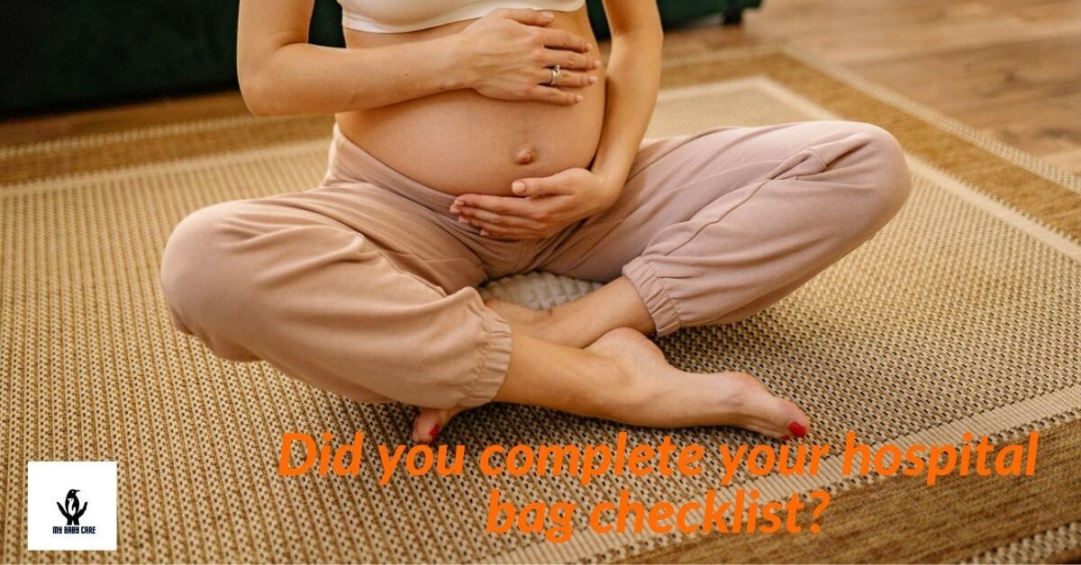 A pregnant mom sitting on a mat