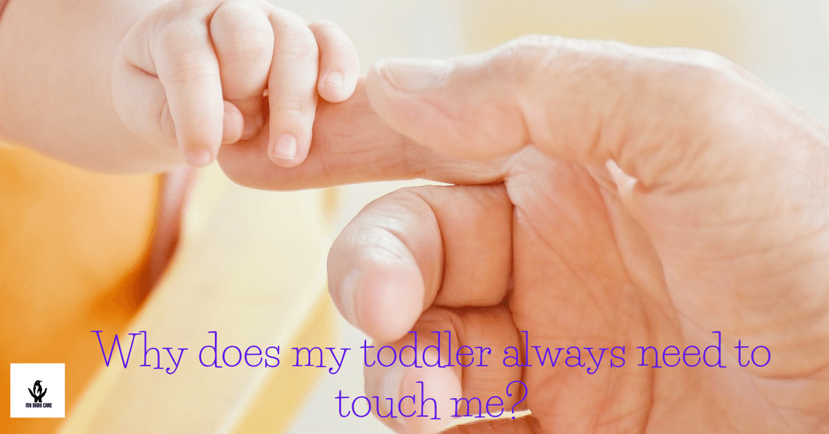 baby is touching his father's finger