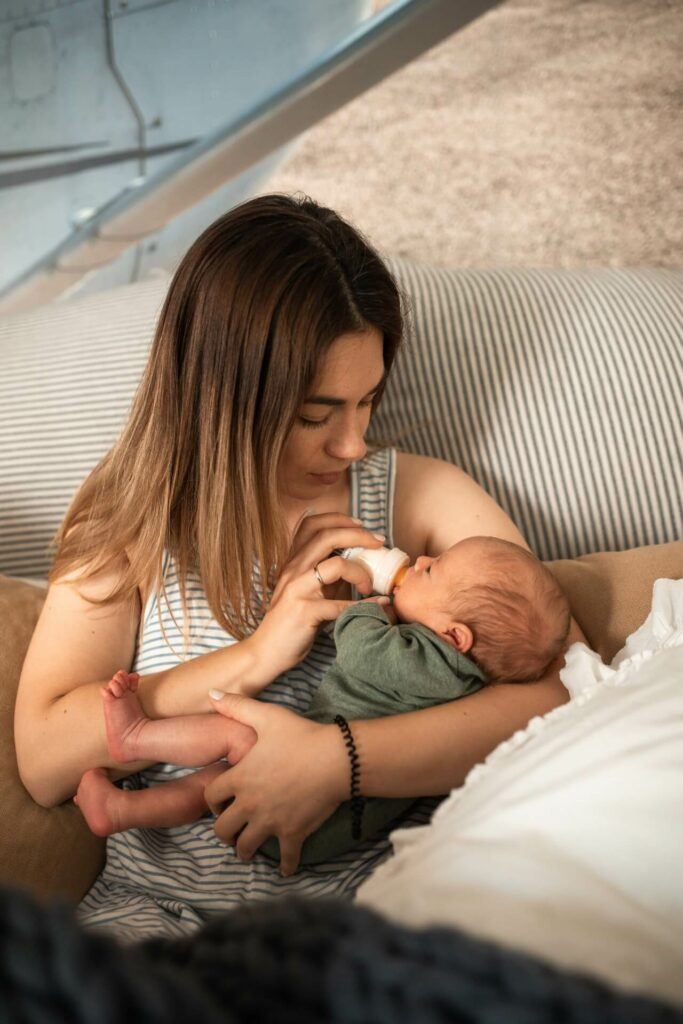 mother feeds her baby with a baby bottle

