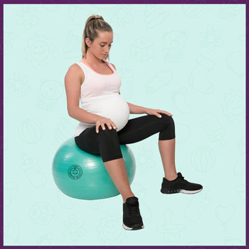 Pregnant mom is sitting on a birth ball